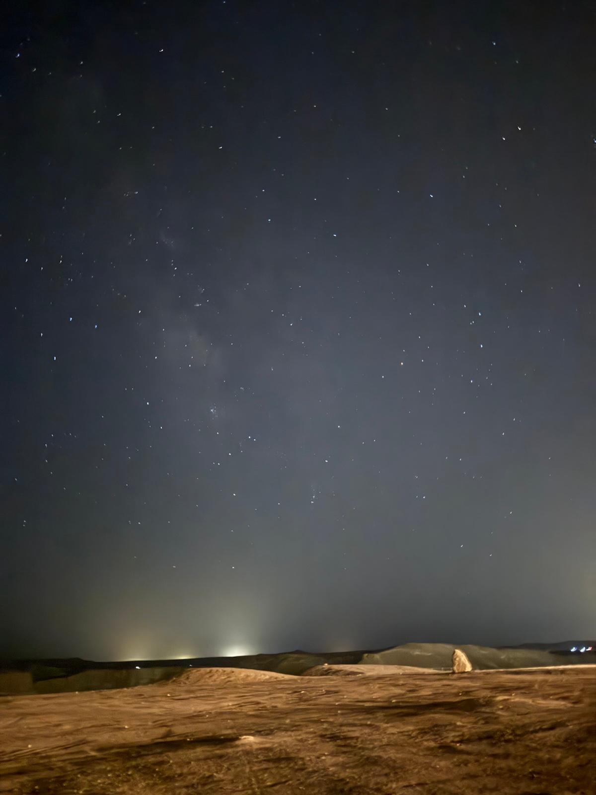 A star-filled night sky over the desert